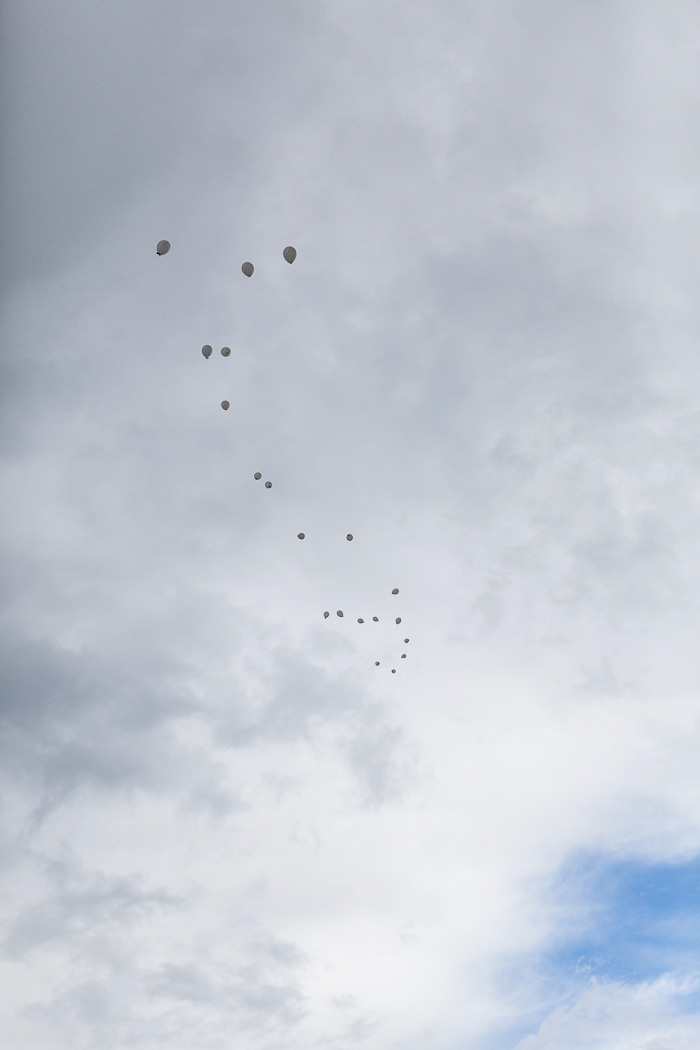 Bride and groom releasing balloons