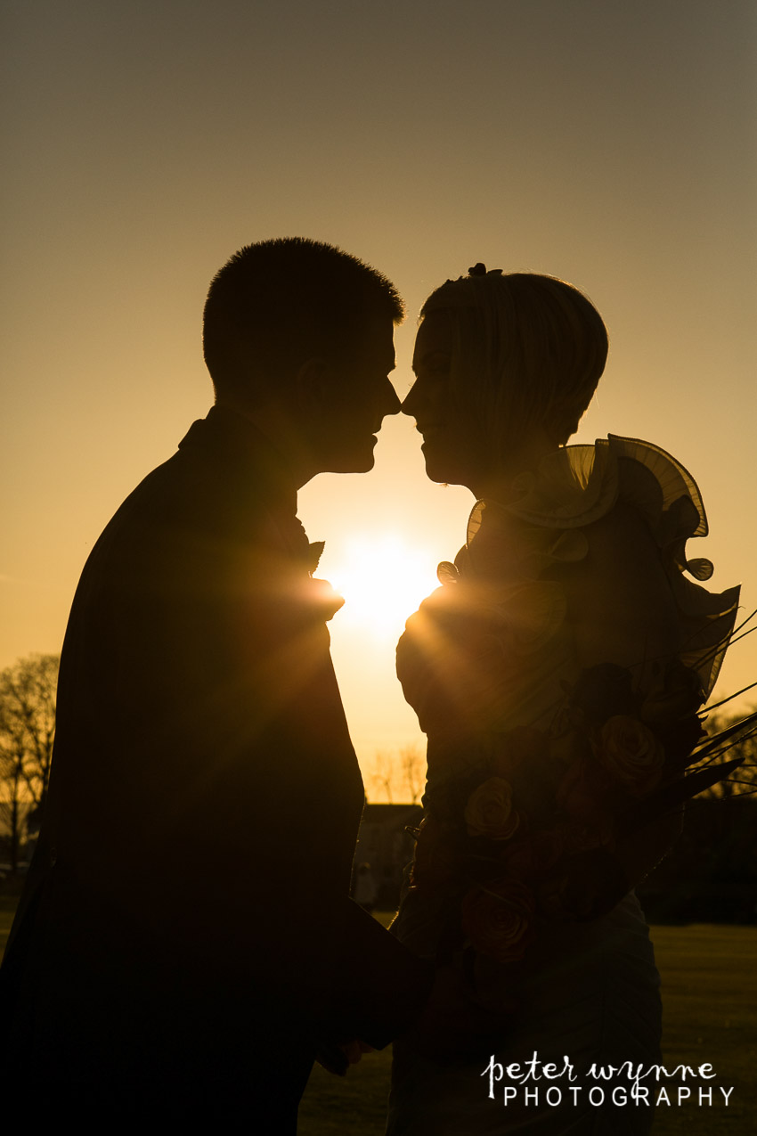 Bride and groom sunset portrait