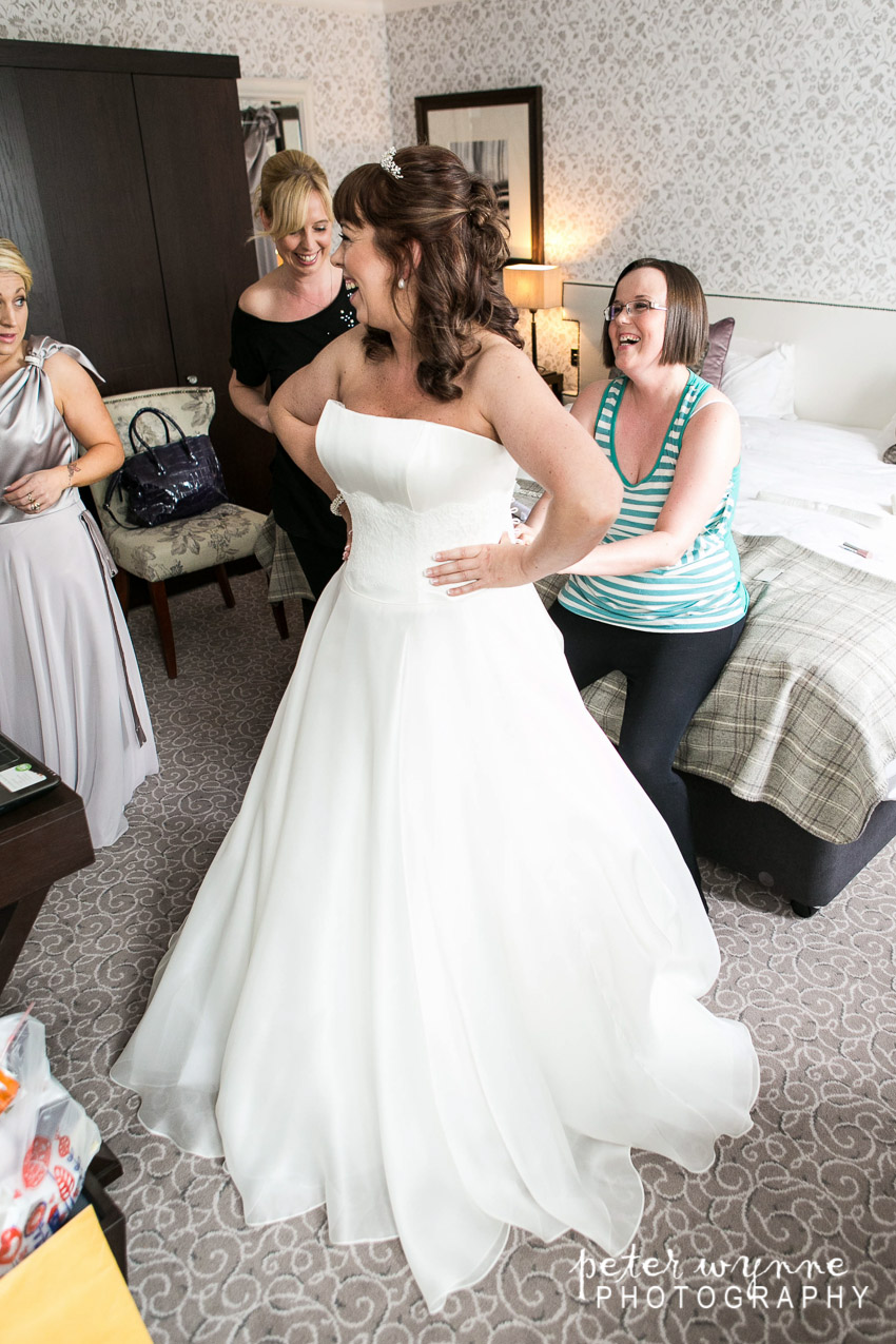 Bride putting dress on