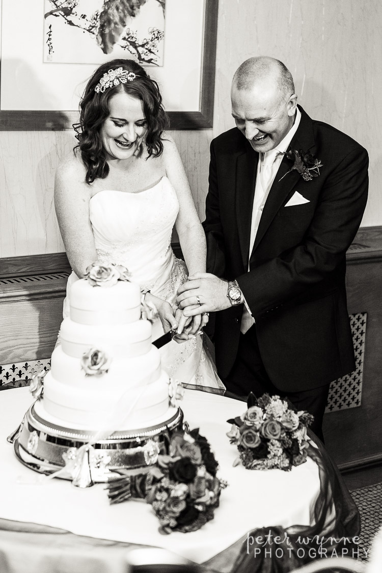 Bride and groom cutting cake