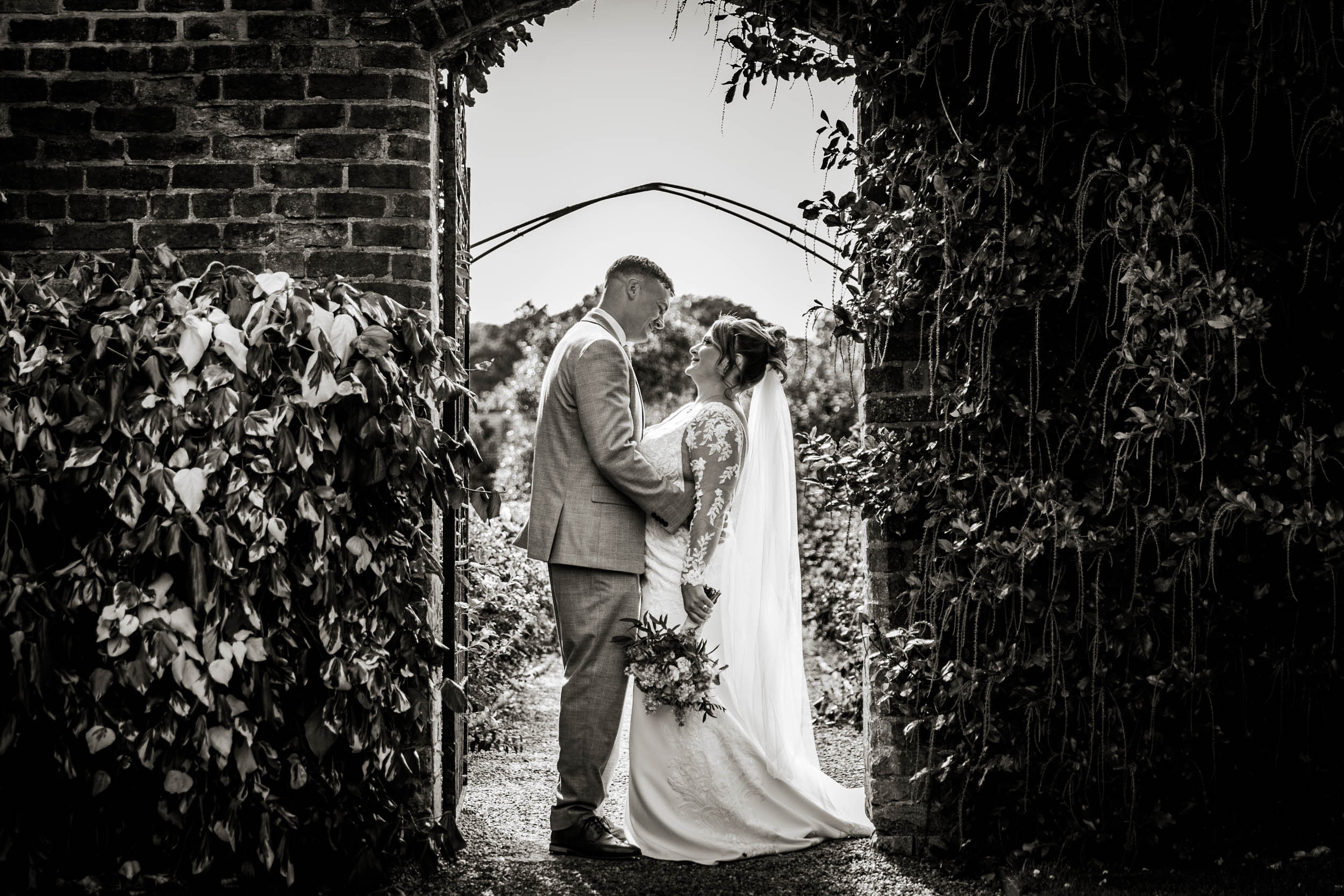 Bride and groom portrait in gardens at Arley Hall