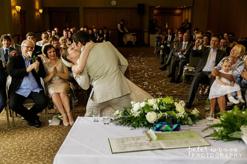 groom kissing bride after ceremony