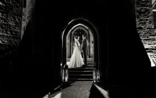 bridal portrait inside arch of Peckforton Castle