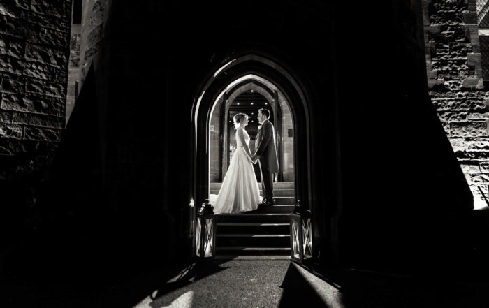 bridal portrait inside arch of Peckforton Castle