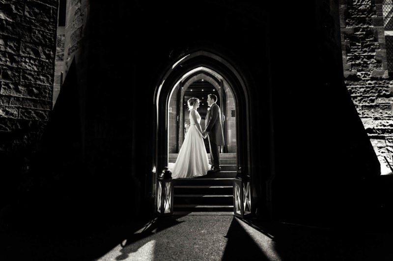 bridal portrait inside arch of Peckforton Castle