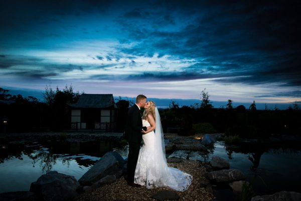 bride and groom kissing at sunset grosvenor pulford