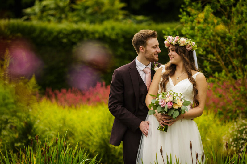 bride and groom looking at each other in gardens at abbeywood estate