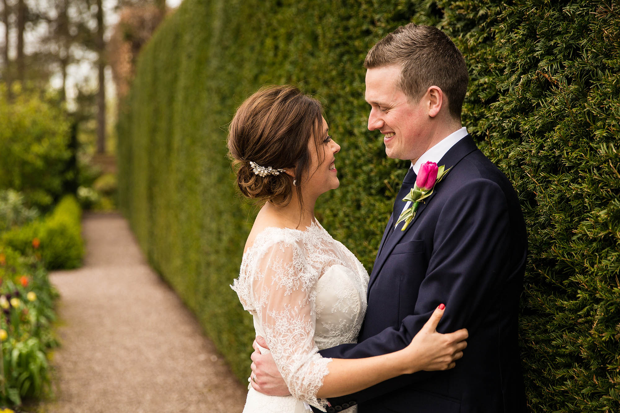 bride and groom looking at each other in gardens at abbeywood estate wedding