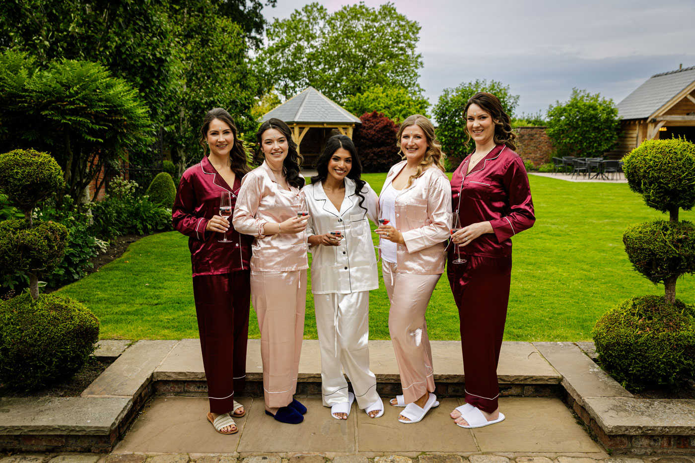 group photo of bride and bridesmaids in gardens at colshaw hall