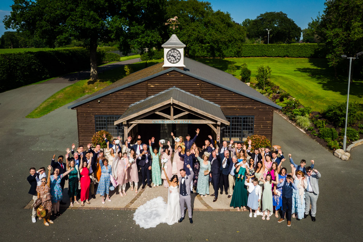 drone group photo outside ceremony hall at colshaw hall wedding