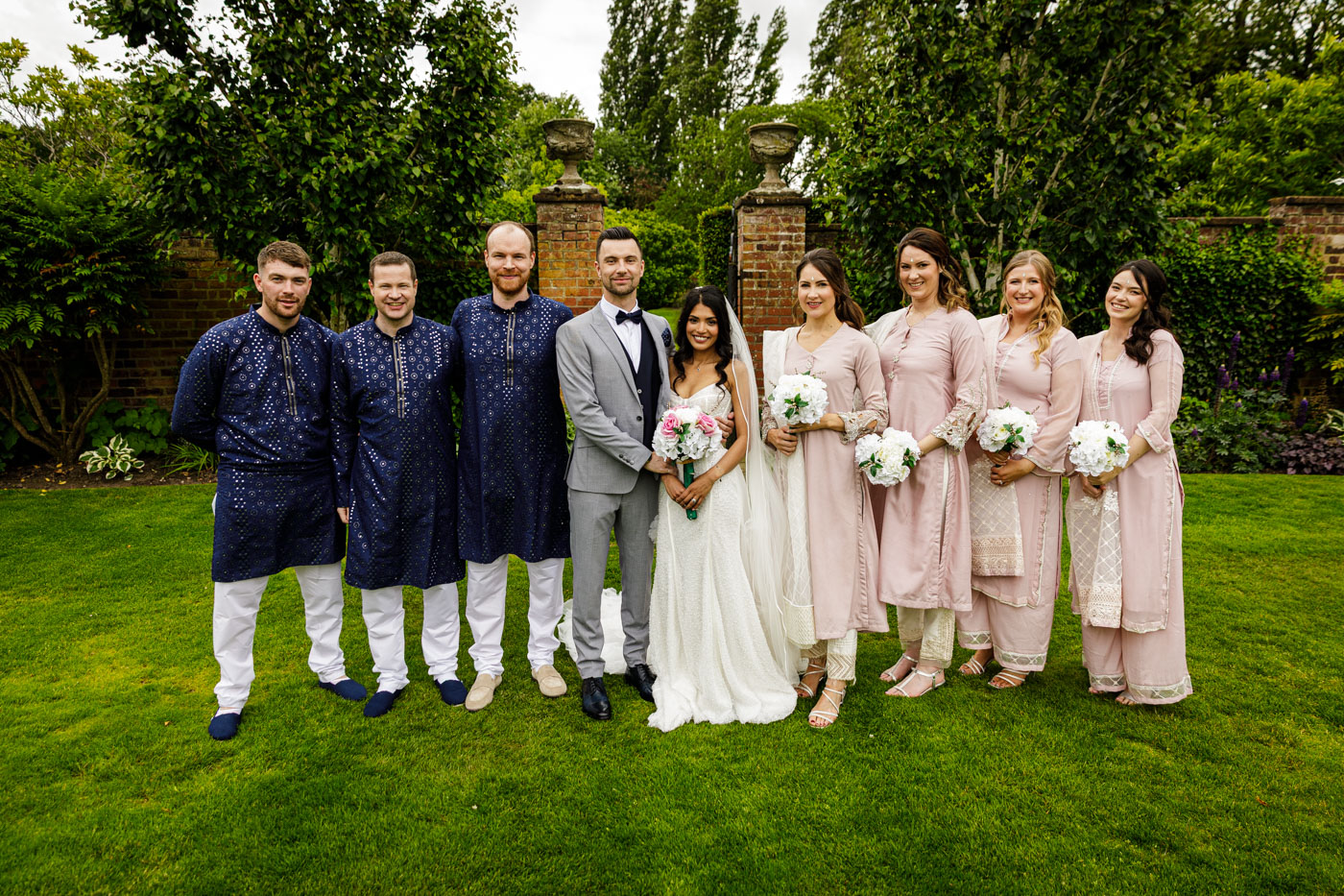 bridal party group photo in gardens at colshaw hall