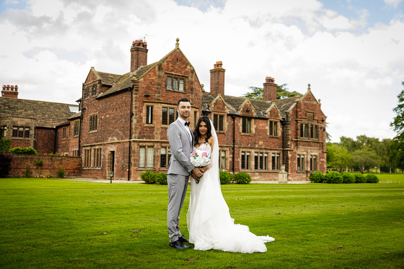 bride and groom portrait in front of colshaw hall