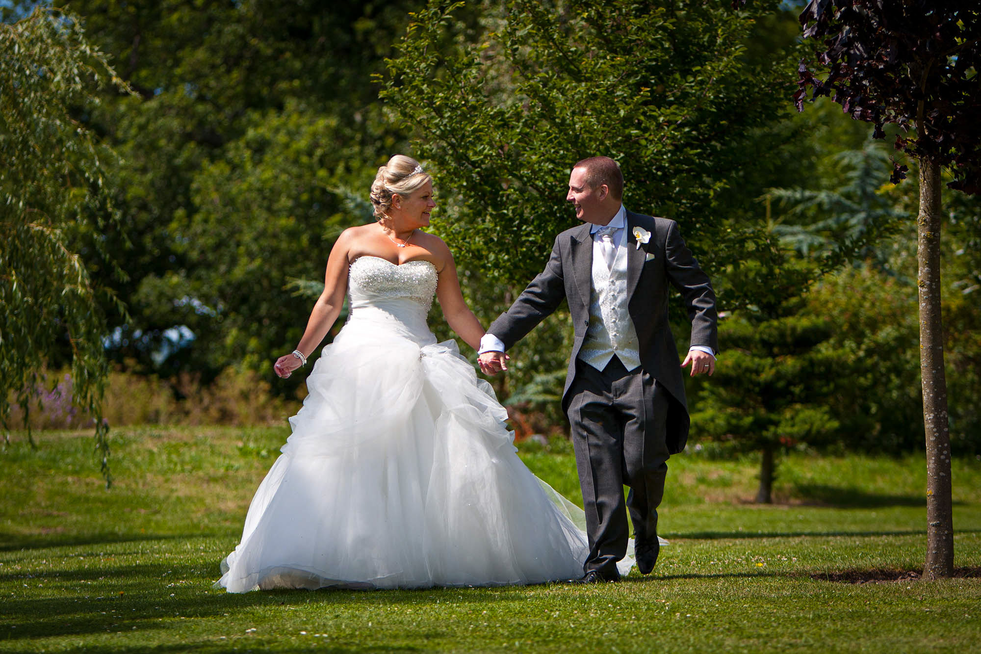 bride and groom walking in gardens at the grosvenor pulford