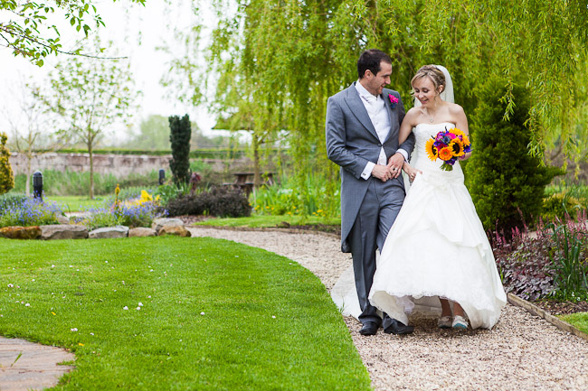 bride and groom walking through gardens at the grosvenor pulford