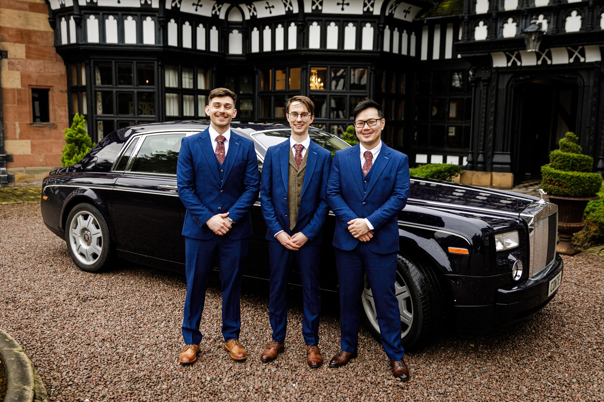 groom and groomsmen with rolls royce wedding car
