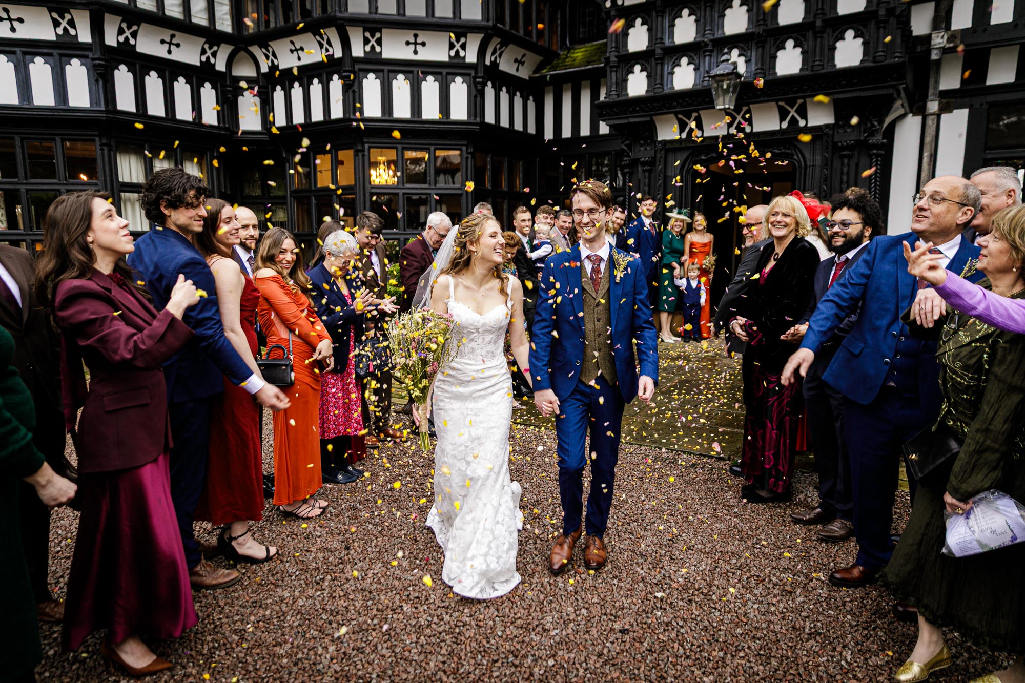bride and groom walking through confetti corridor at hillbark hotel