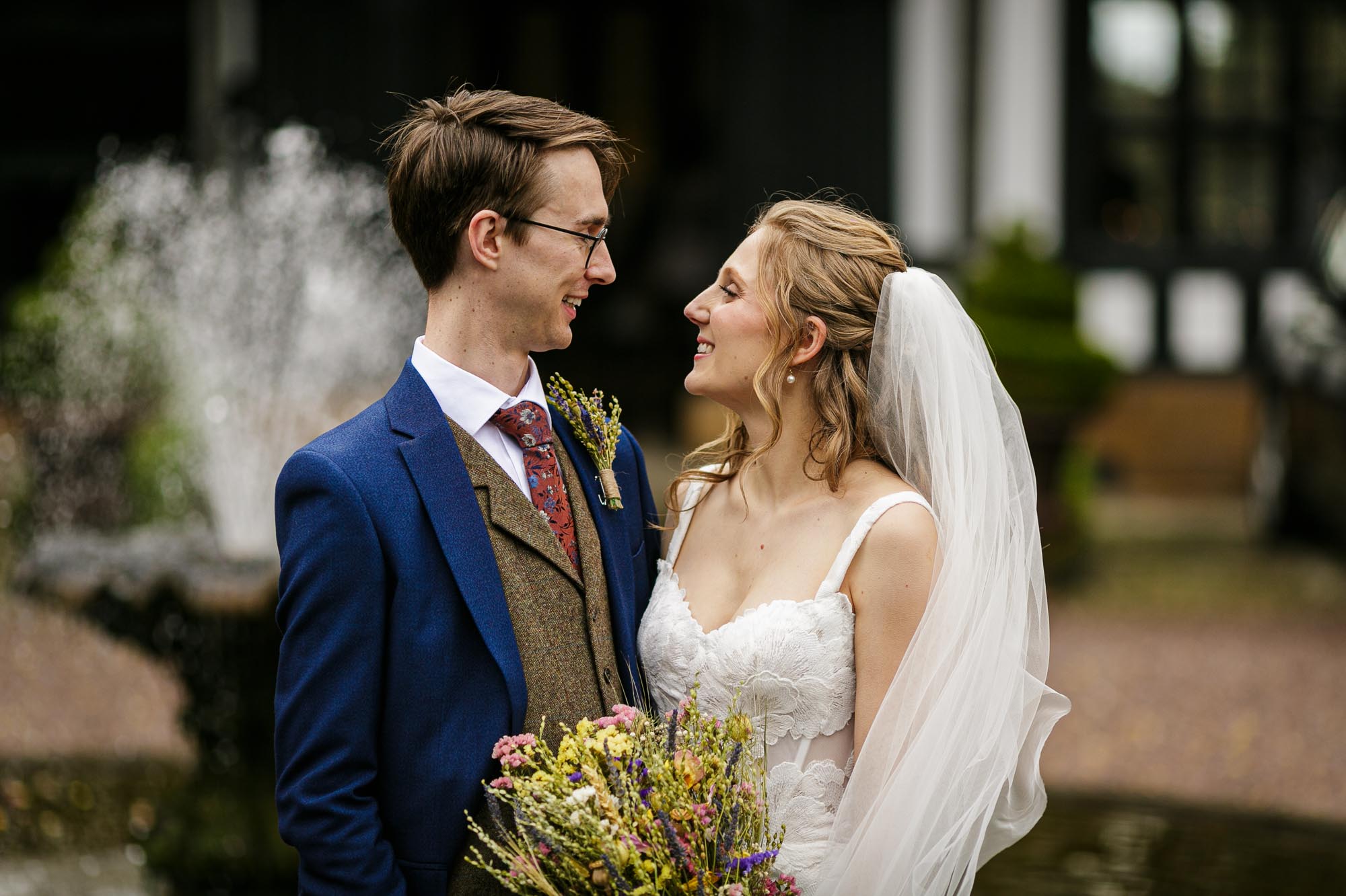 bride and groom portrait in front of fountain at hillbark hotel