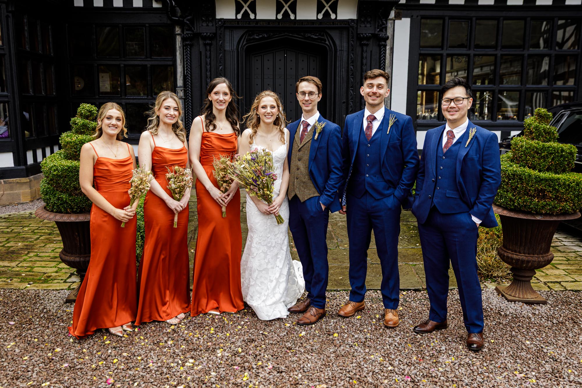bridal party group photo in front of hillbark hotel