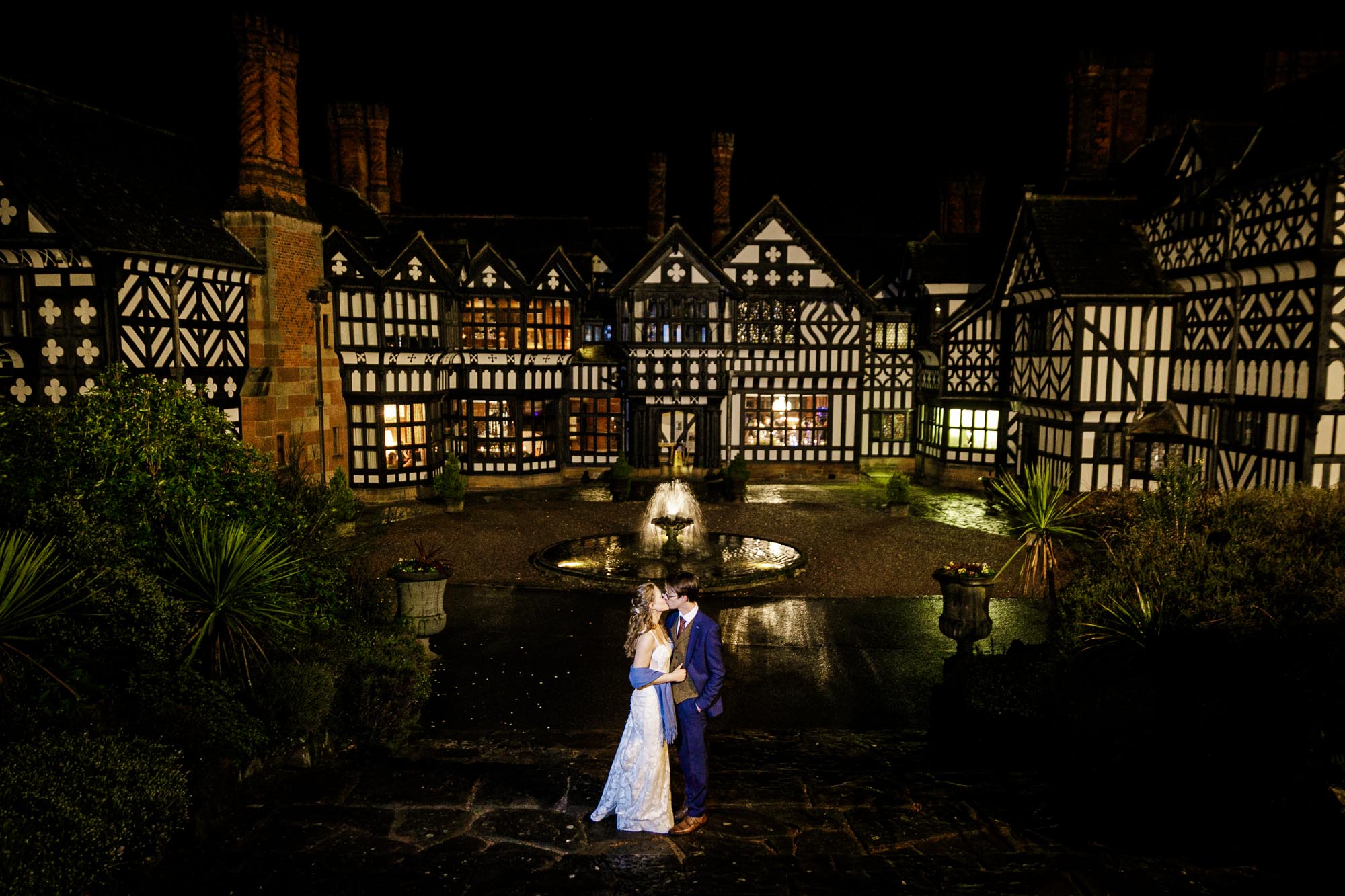 bride and groom kissing at night in front of hilbark hotel wedding venue