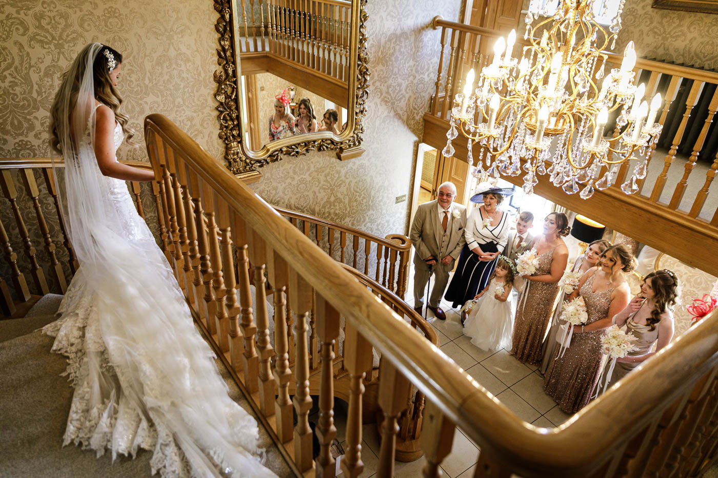 bride greeting family and bridesmaids on stairs at merrydale manor
