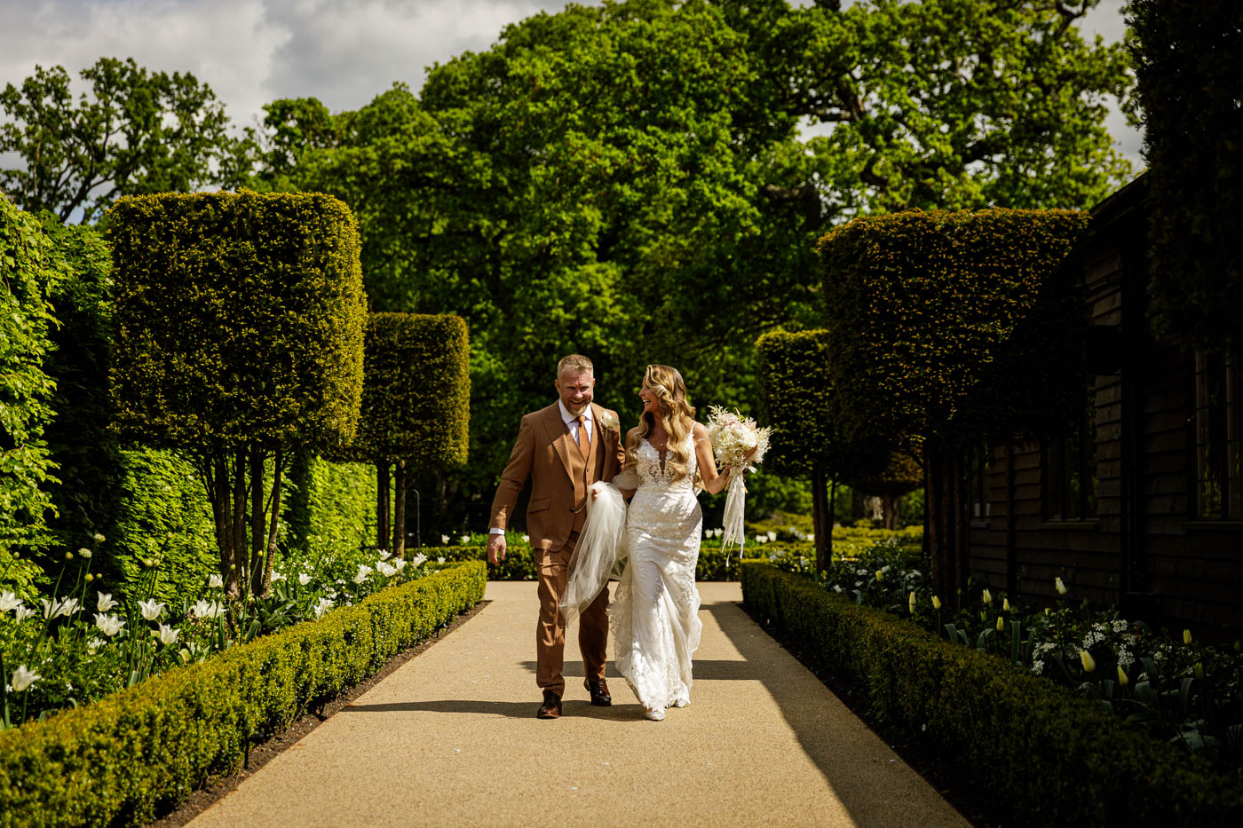bride and goom walking and laughing