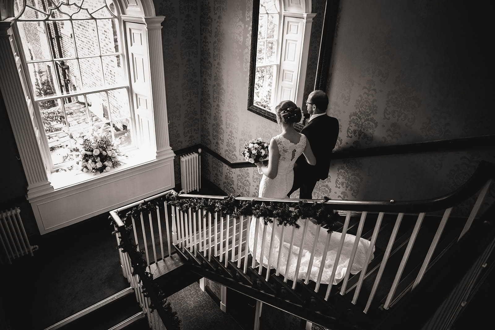 bride and father walking down stairs at mottram hall