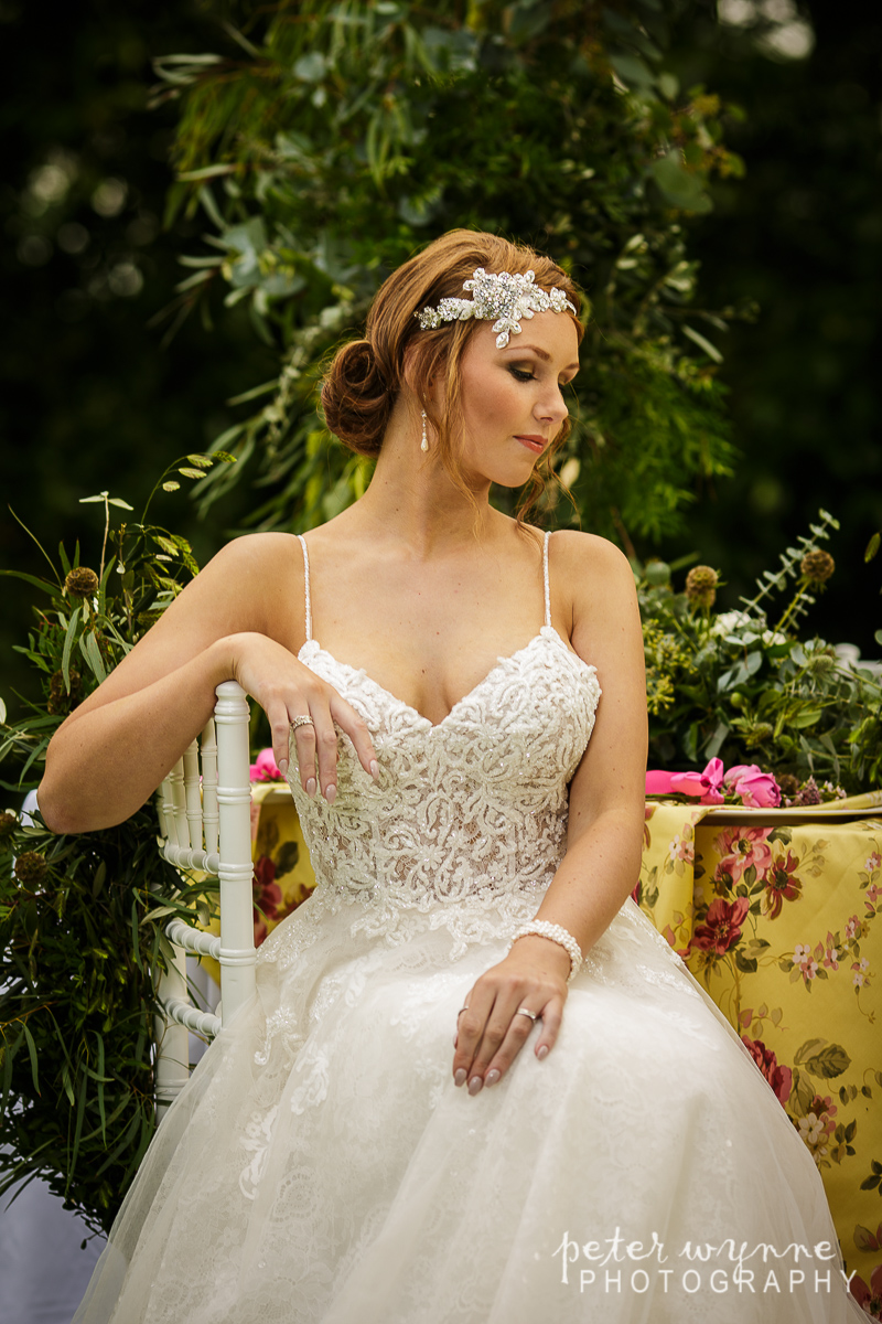 Bride sitting at outdoor table at Wrenbury Hall
